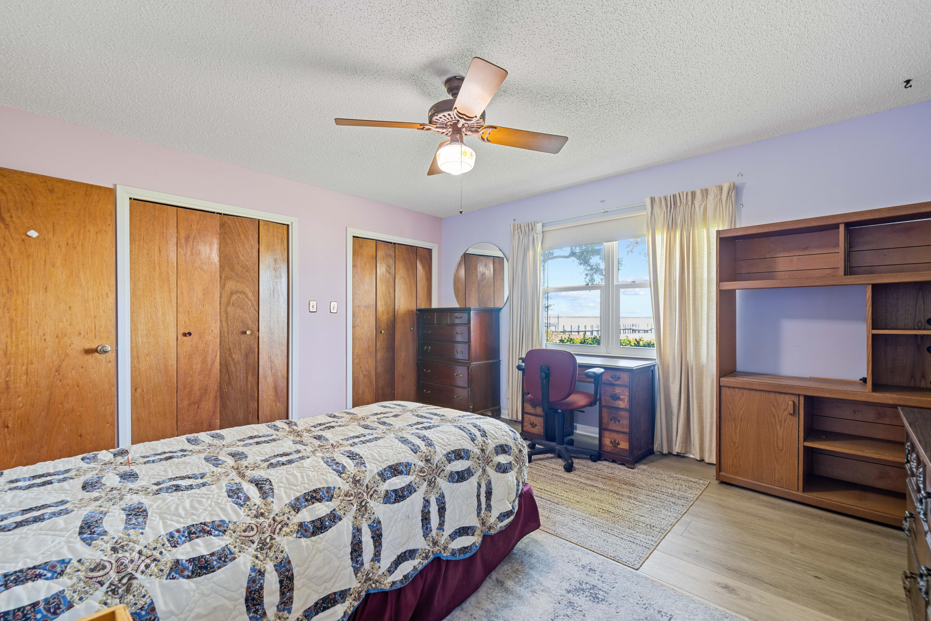 2744 Bay Grove Road Freeport, FL 32439 - Photo 22 of 45 a bedroom with a bed and dresser with wooden floor