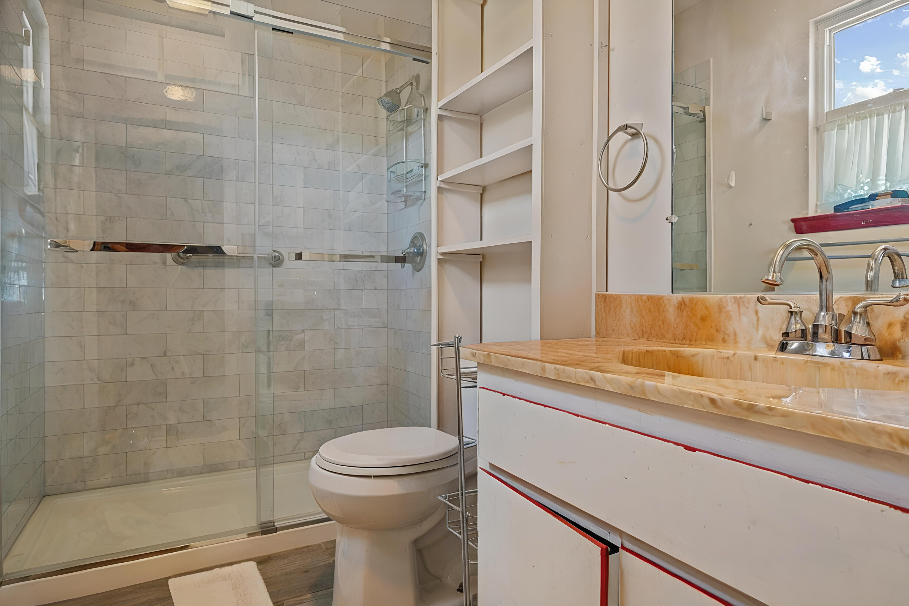 2744 Bay Grove Road Freeport, FL 32439 - Photo 24 of 45 a bathroom with a granite countertop sink a toilet and shower