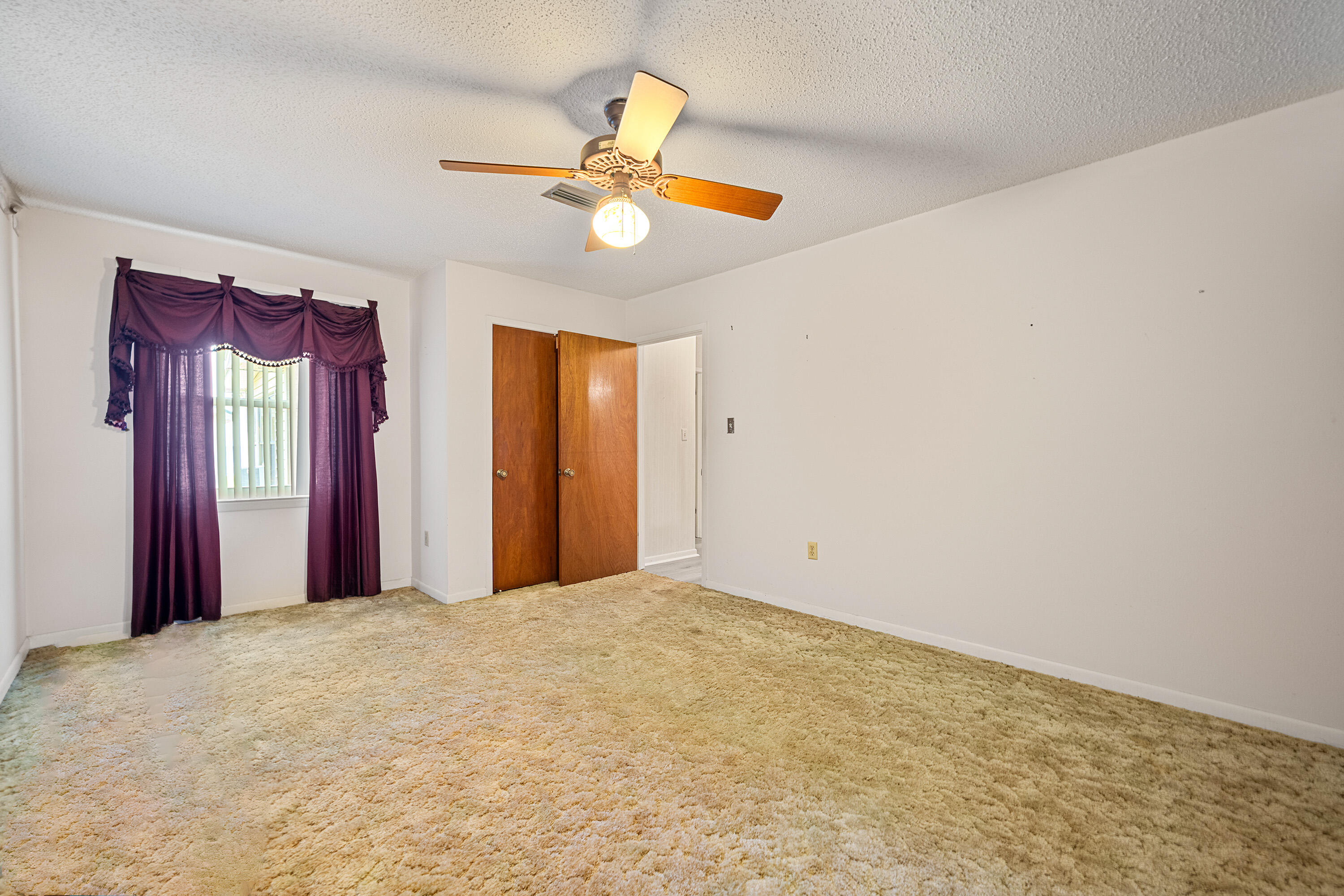 2744 Bay Grove Road Freeport, FL 32439 - Photo 26 of 45 a view of a livingroom with a chandelier fan and a window