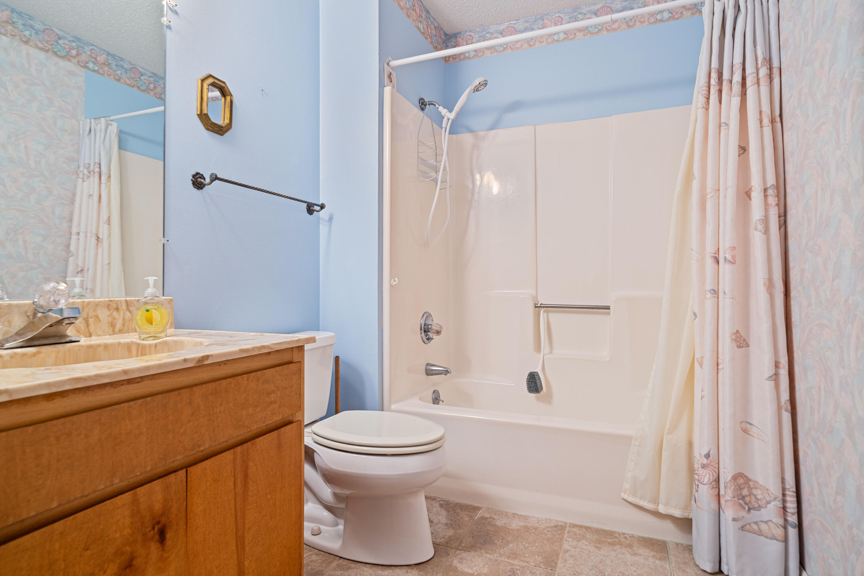 2744 Bay Grove Road Freeport, FL 32439 - Photo 27 of 45 a bathroom with a sink a toilet and shower