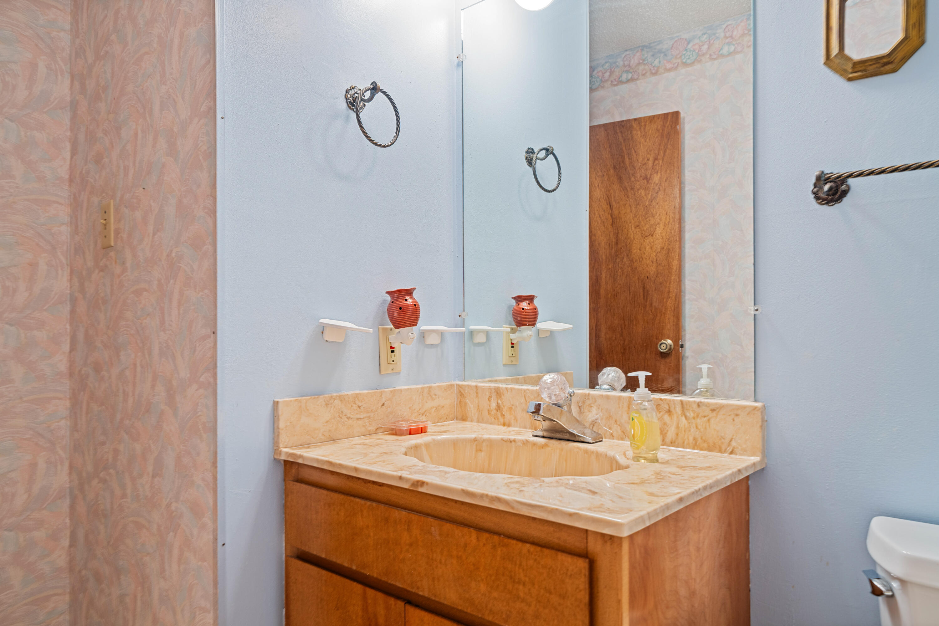 2744 Bay Grove Road Freeport, FL 32439 - Photo 28 of 45 a bathroom with a sink and a mirror