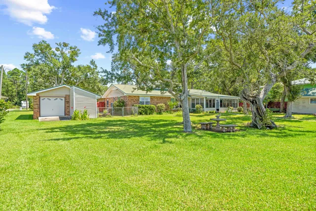a front view of house with yard and green space