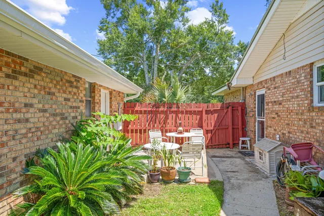 a backyard of a house with a garden and outdoor seating