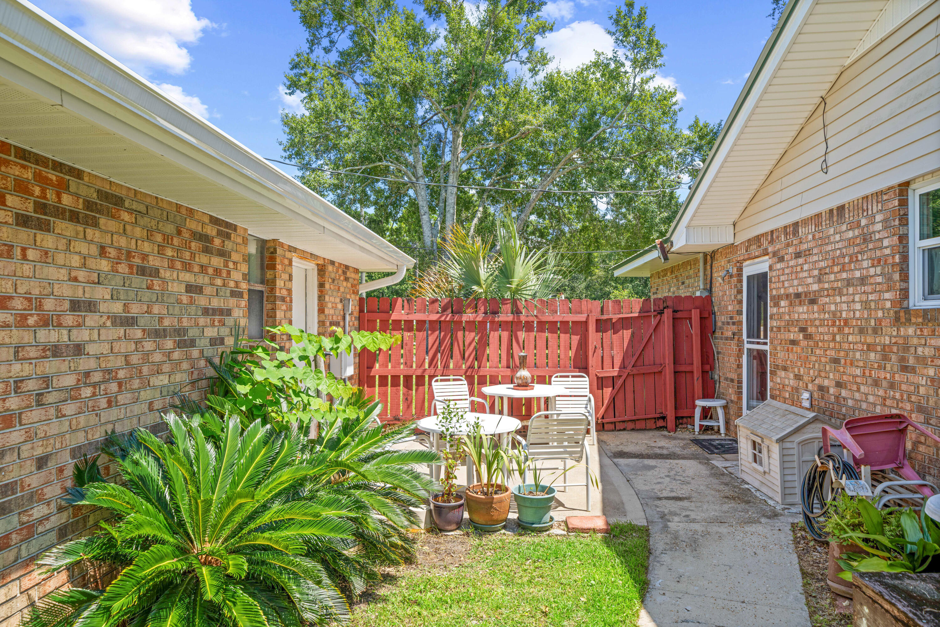 2744 Bay Grove Road Freeport, FL 32439 - Photo 32 of 45 a backyard of a house with a garden and outdoor seating