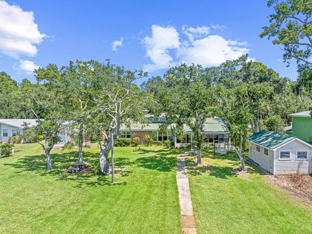 a backyard of a house with table and chairs