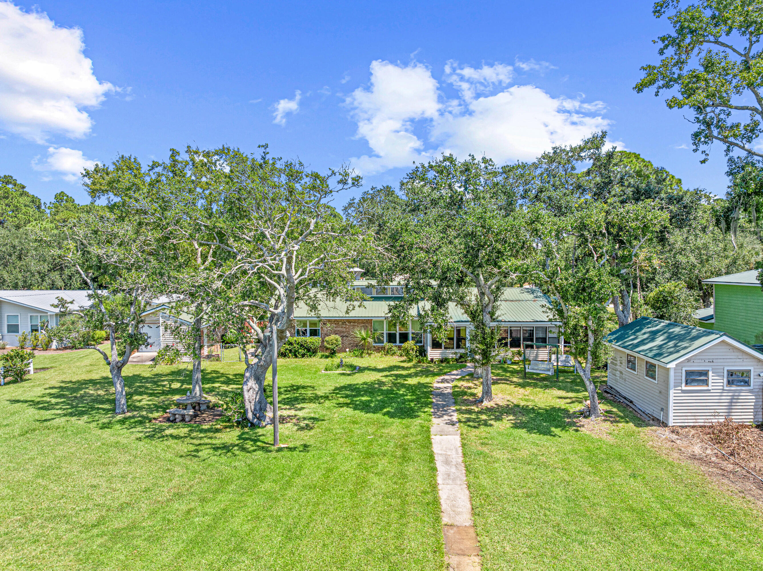 2744 Bay Grove Road Freeport, FL 32439 - Photo 34 of 45 a backyard of a house with table and chairs
