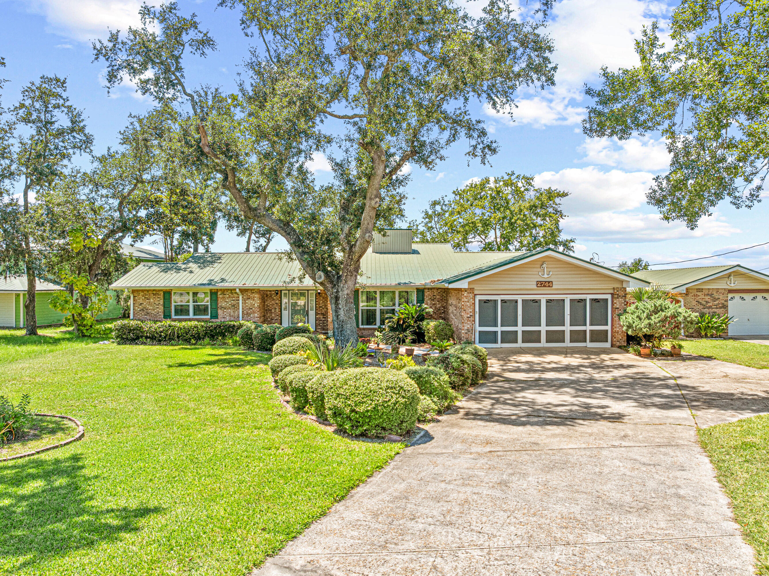 2744 Bay Grove Road Freeport, FL 32439 - Photo 37 of 45 a front view of a house with a garden