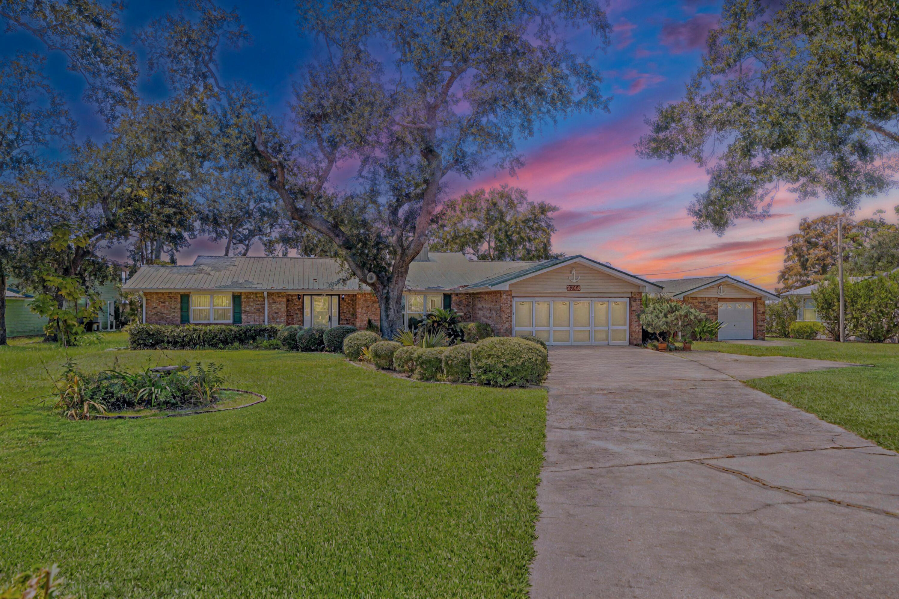 2744 Bay Grove Road Freeport, FL 32439 - Photo 39 of 45 a front view of a house with garden