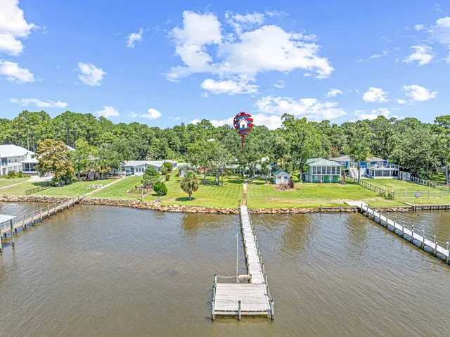 a view of a swimming pool and trees in the background