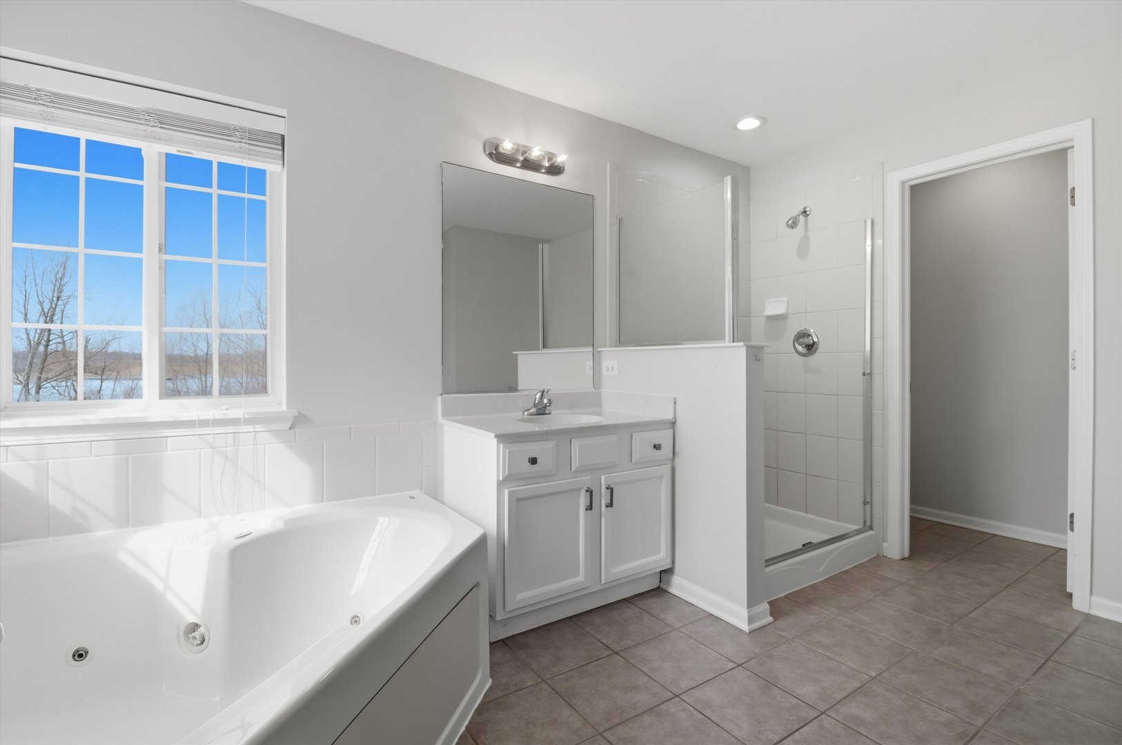 2511 Hennig Road Hampshire, IL 60140 - Photo 16 of 44 a spacious bathroom with a double vanity sink and a mirror