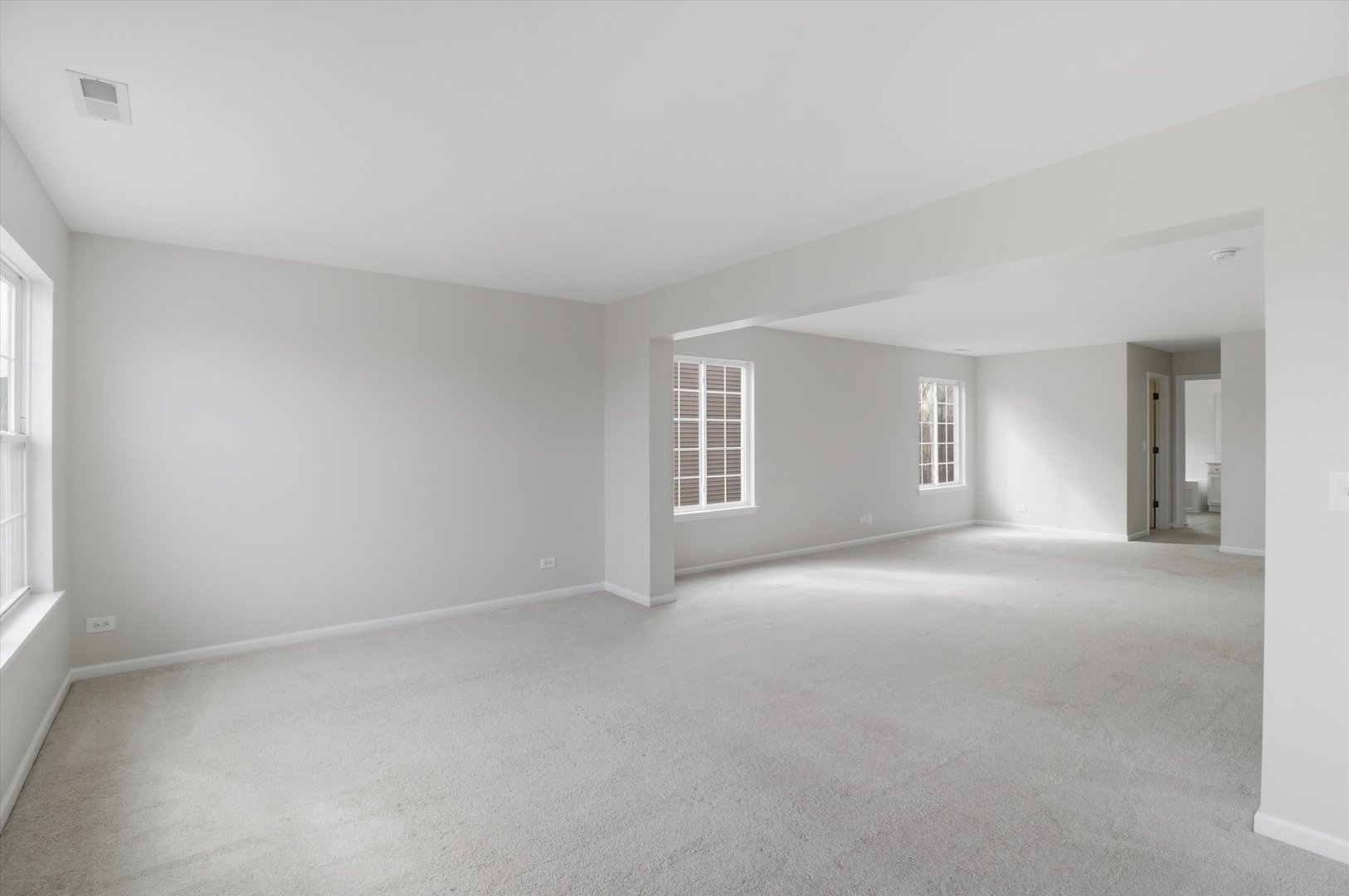 2511 Hennig Road Hampshire, IL 60140 - Photo 20 of 44 a view of a big room with windows and chandelier fan