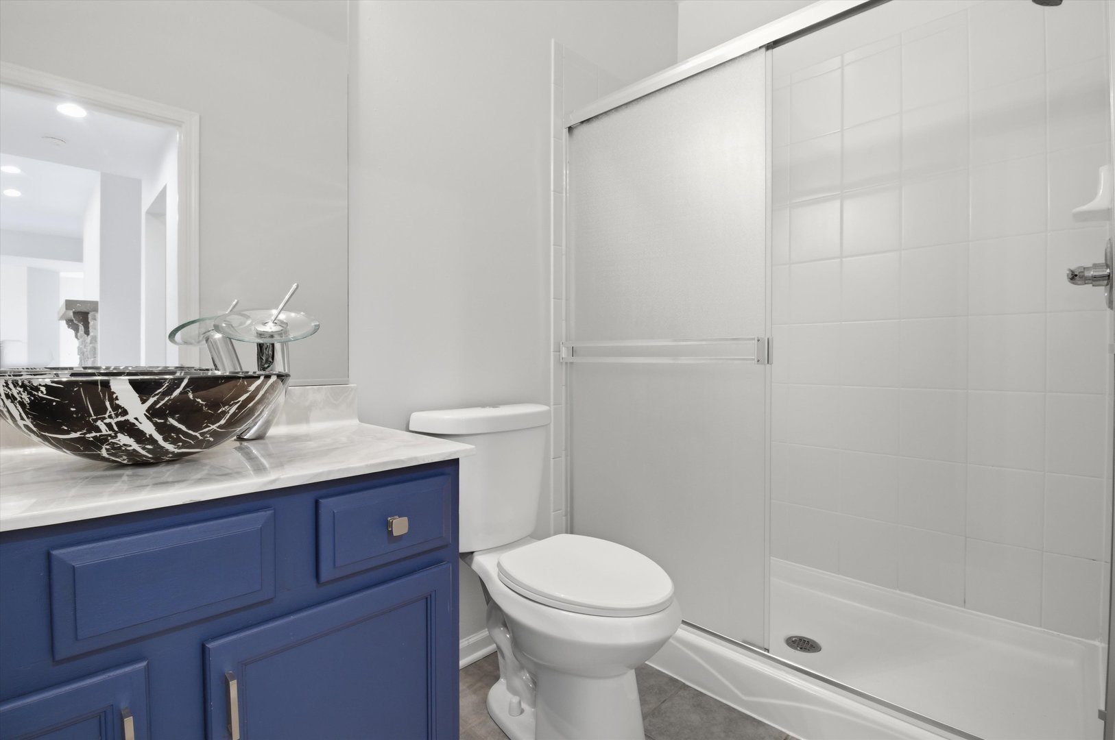 2511 Hennig Road Hampshire, IL 60140 - Photo 33 of 44 a bathroom with a granite countertop sink a toilet and shower