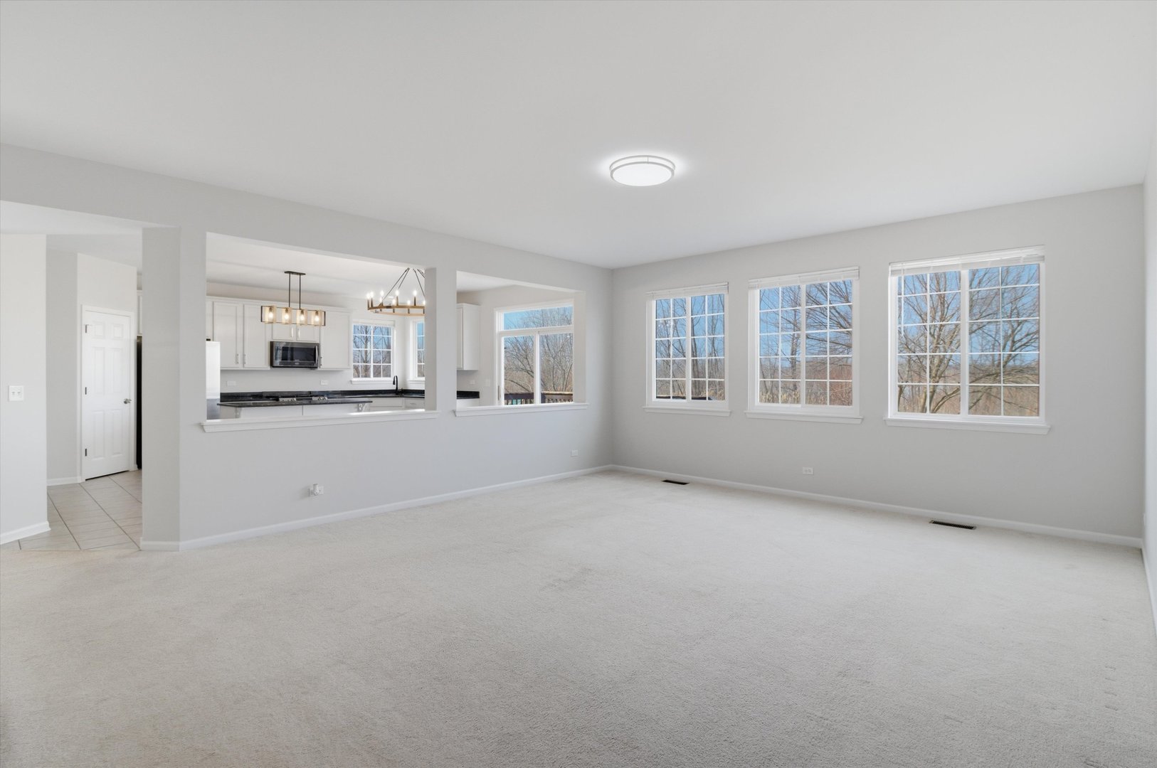 2511 Hennig Road Hampshire, IL 60140 - Photo 8 of 44 an empty room with a kitchen and windows