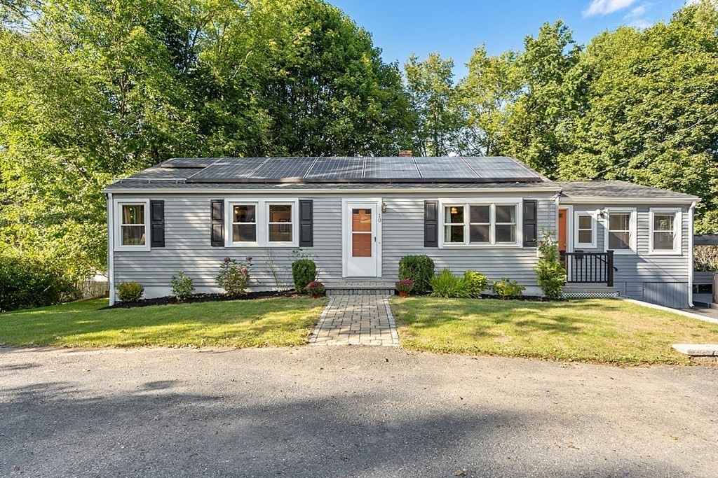 a view of a yard with a house and a tree