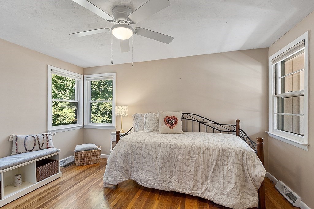 10 Truro Street Worcester, MA 01603 - Photo 11 of 32 a bedroom with a bed a chandelier and a window