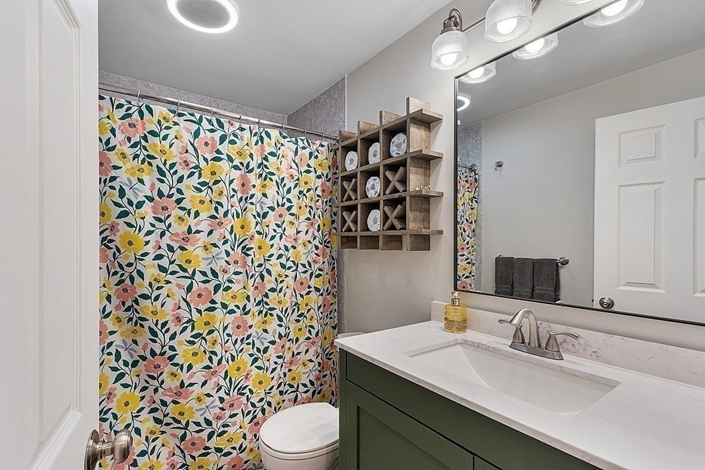 10 Truro Street Worcester, MA 01603 - Photo 13 of 32 a bathroom with a sink toilet and shower