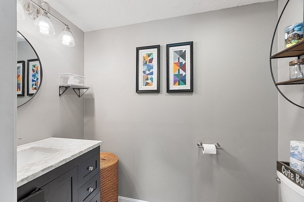 10 Truro Street Worcester, MA 01603 - Photo 18 of 32 a bathroom with a granite countertop sink mirror vanity and toilet