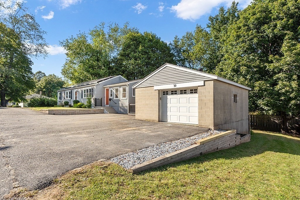 10 Truro Street Worcester, MA 01603 - Photo 2 of 32 a front view of a house with a yard and garage