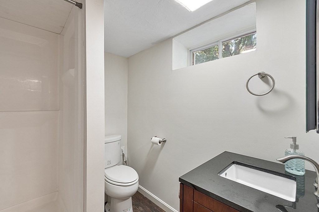 10 Truro Street Worcester, MA 01603 - Photo 24 of 32 a bathroom with a granite countertop toilet and a sink