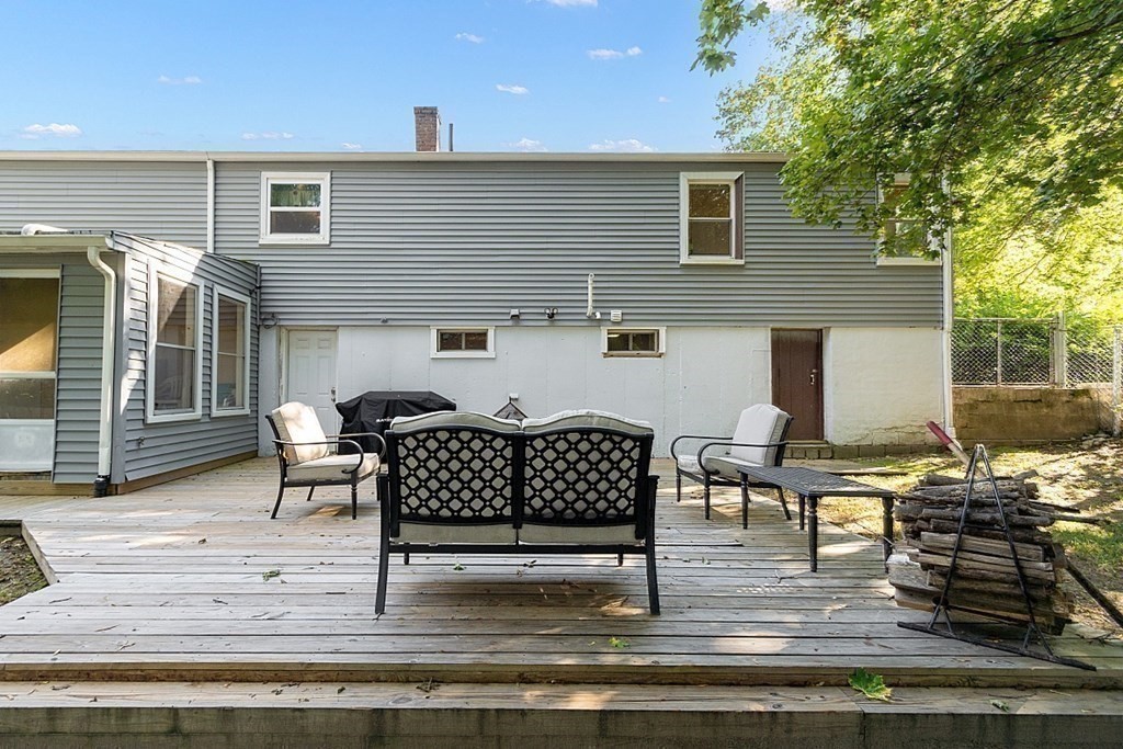 10 Truro Street Worcester, MA 01603 - Photo 27 of 32 a view of a patio with table and chairs with wooden floor and fence