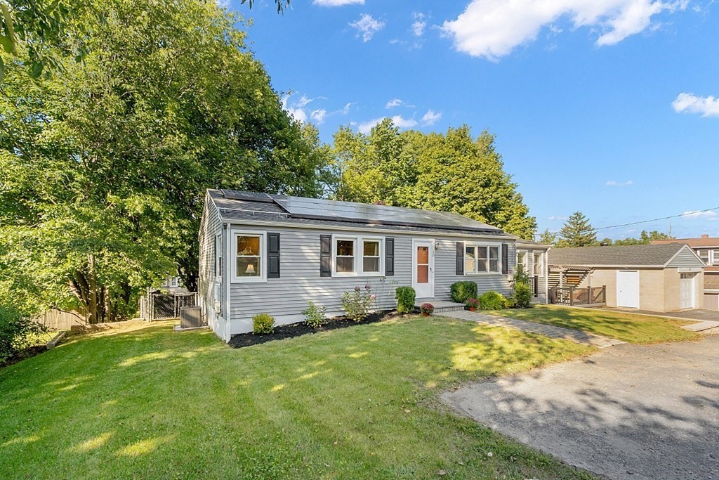 10 Truro Street Worcester, MA 01603 - Photo 3 of 32 a view of a house with a big yard and potted plants and large trees