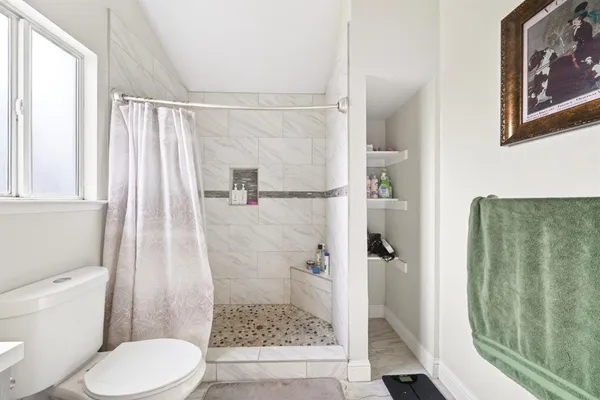 a bathroom with a toilet and shower