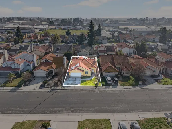 an aerial view of residential houses with outdoor space