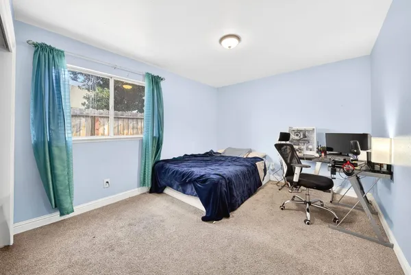 a livingroom with workspace and a window