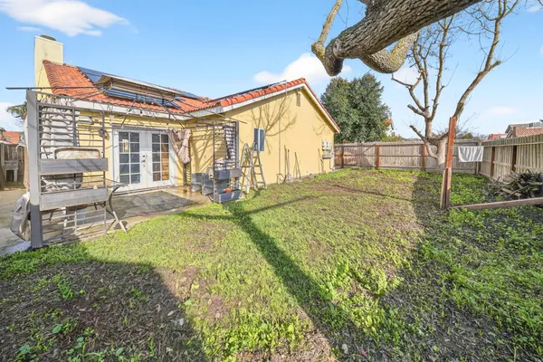 a view of a house with backyard and sitting area