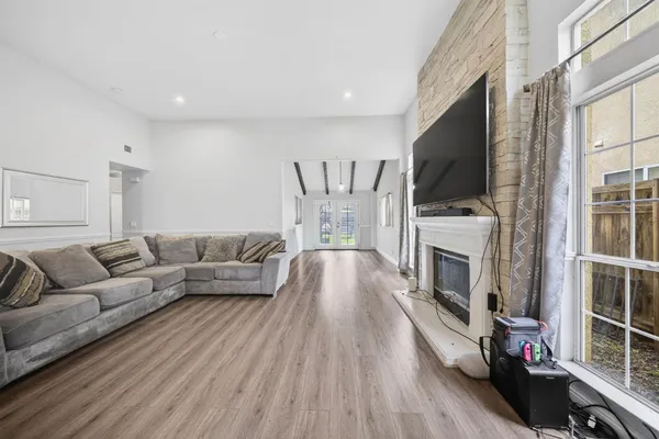 a living room with furniture a flat screen tv and a fireplace