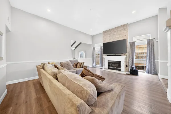 a living room with furniture a fireplace and a flat screen tv
