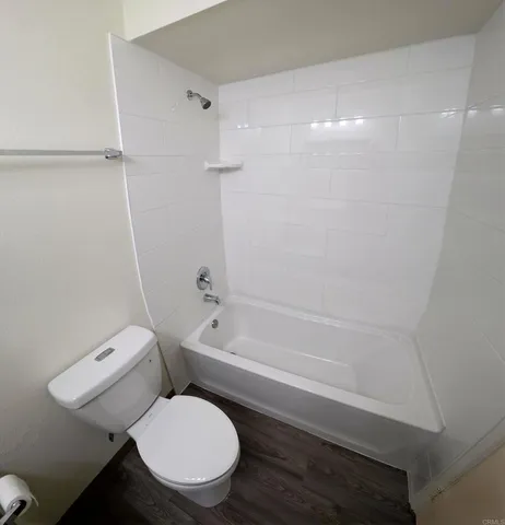 a bathroom with a toilet and a bathtub