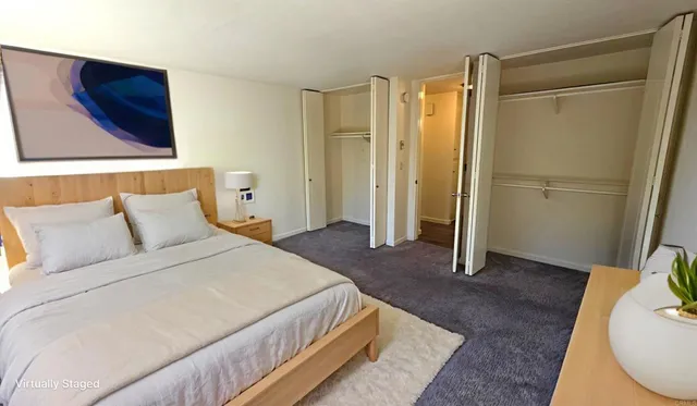 a bedroom with a bed and a mirror