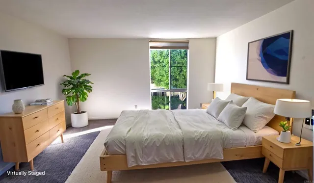 a bedroom with a bed and a flat screen tv