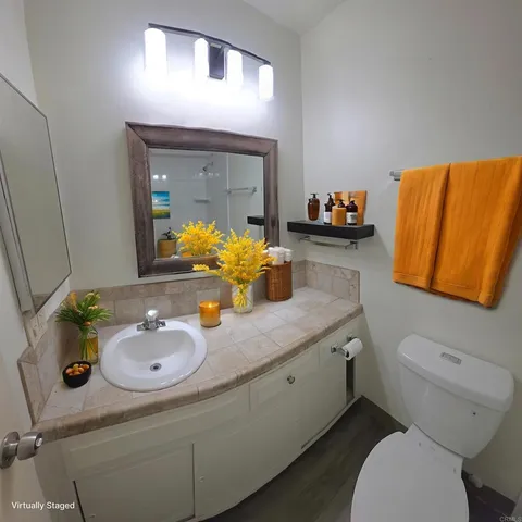 a bathroom with a granite countertop sink and a mirror