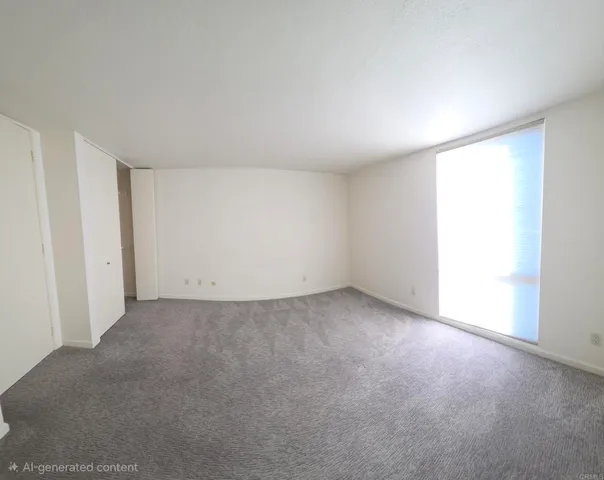 a view of an empty room and a window