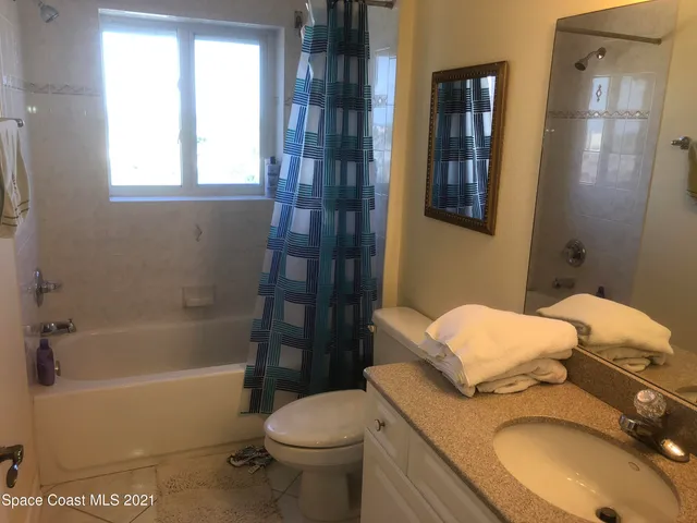 a bathroom with a granite countertop toilet sink and shower