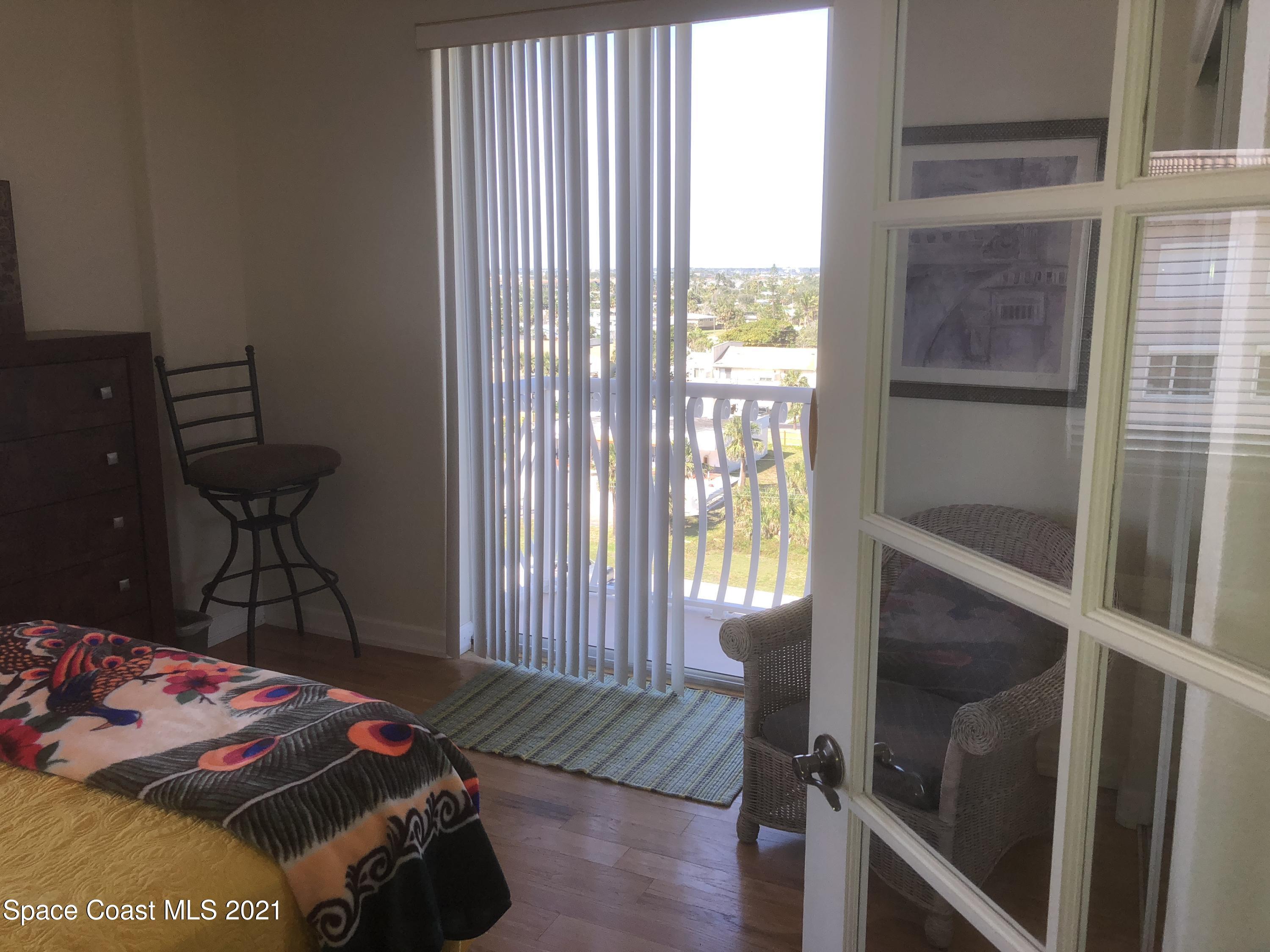 2075 Florida A1A, Unit 2705 Indian Harbour Beach, FL 32937 - Photo 13 of 30 a bedroom with a bed and a window
