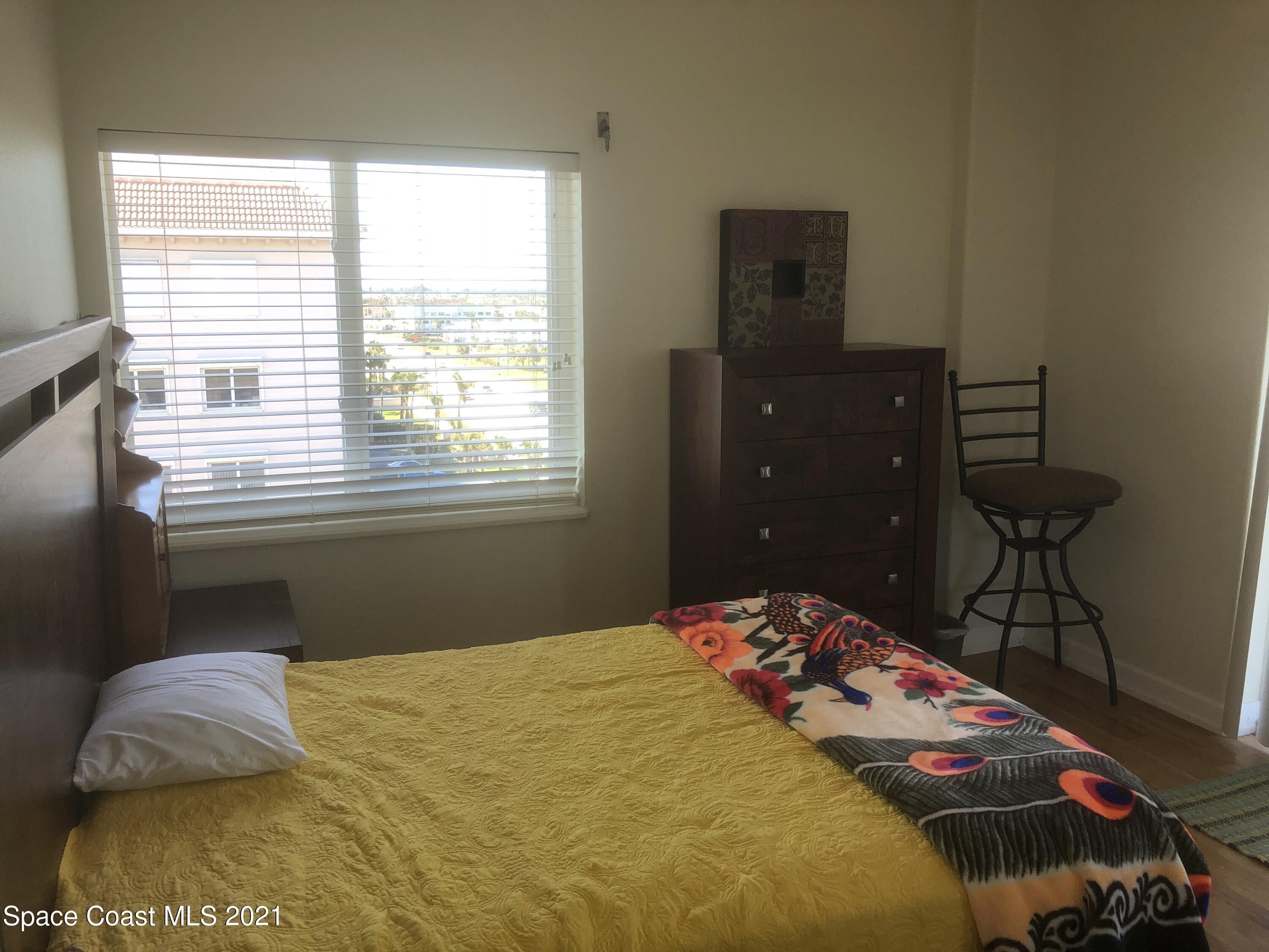 2075 Florida A1A, Unit 2705 Indian Harbour Beach, FL 32937 - Photo 14 of 30 a bedroom with a bed and a window