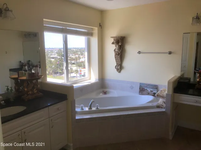 a bath tub sitting in a bathroom next to a window