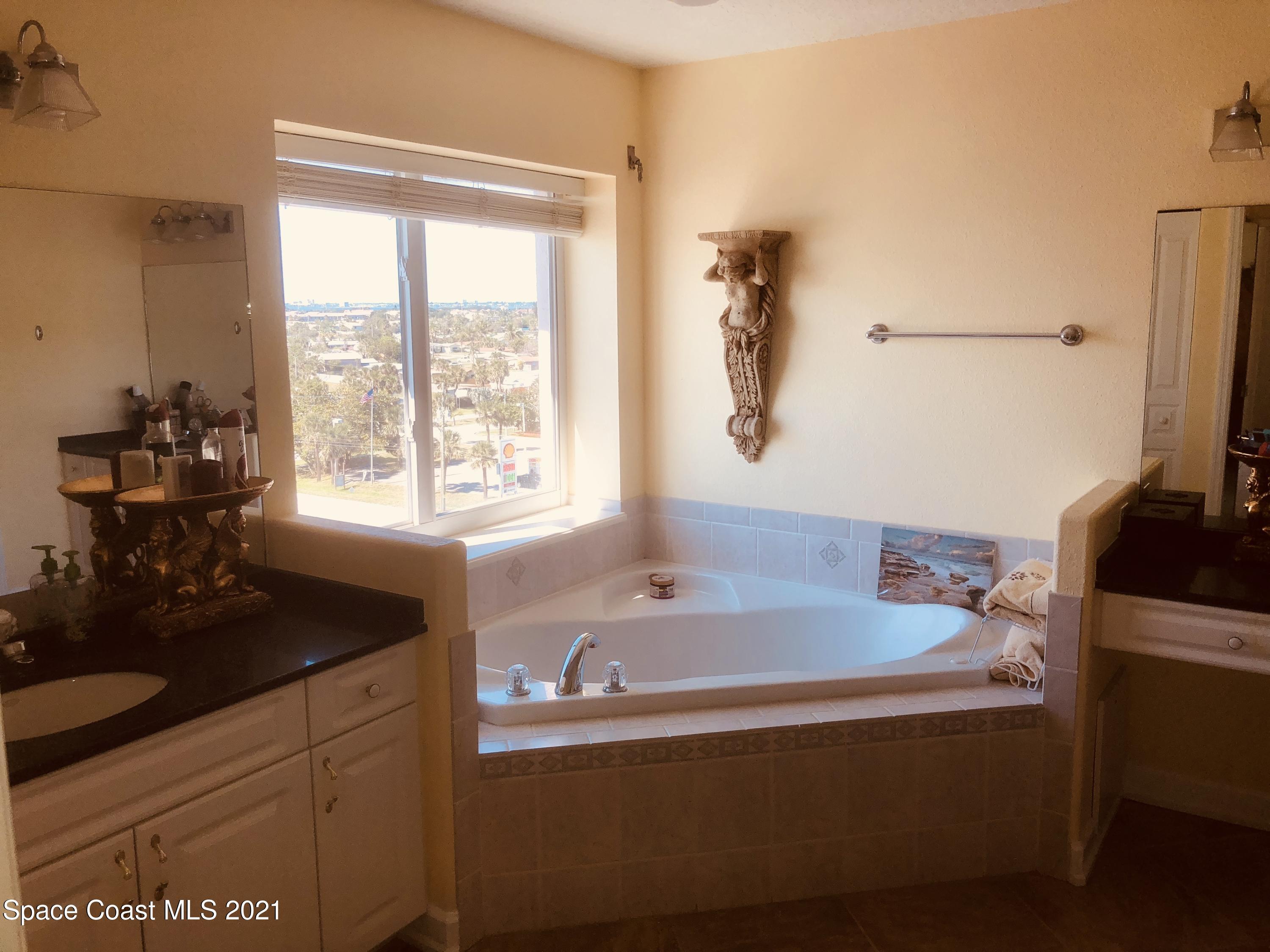 2075 Florida A1A, Unit 2705 Indian Harbour Beach, FL 32937 - Photo 27 of 30 a bath tub sitting next to a window