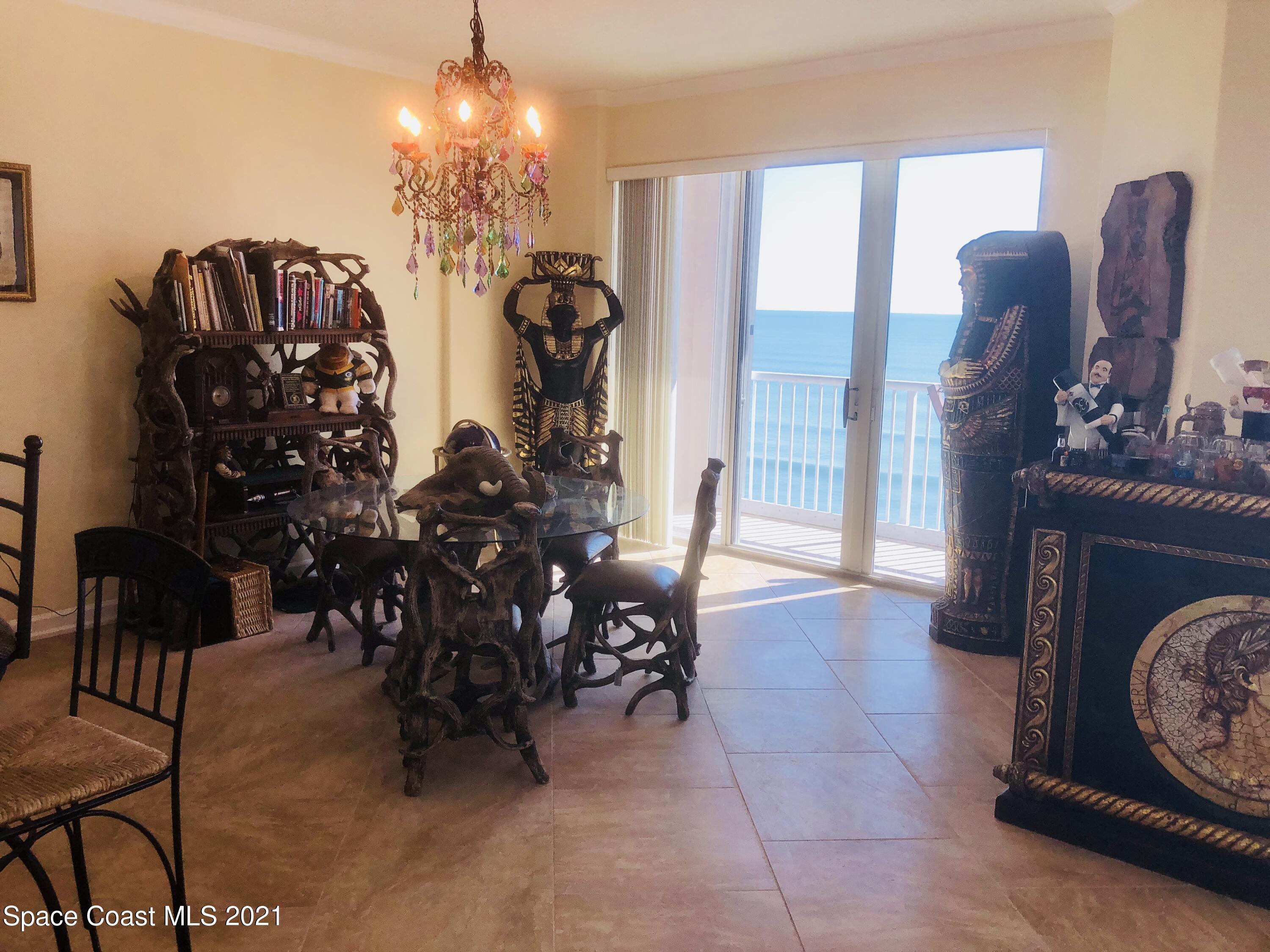2075 Florida A1A, Unit 2705 Indian Harbour Beach, FL 32937 - Photo 3 of 30 a view of a dining room with furniture and chandelier