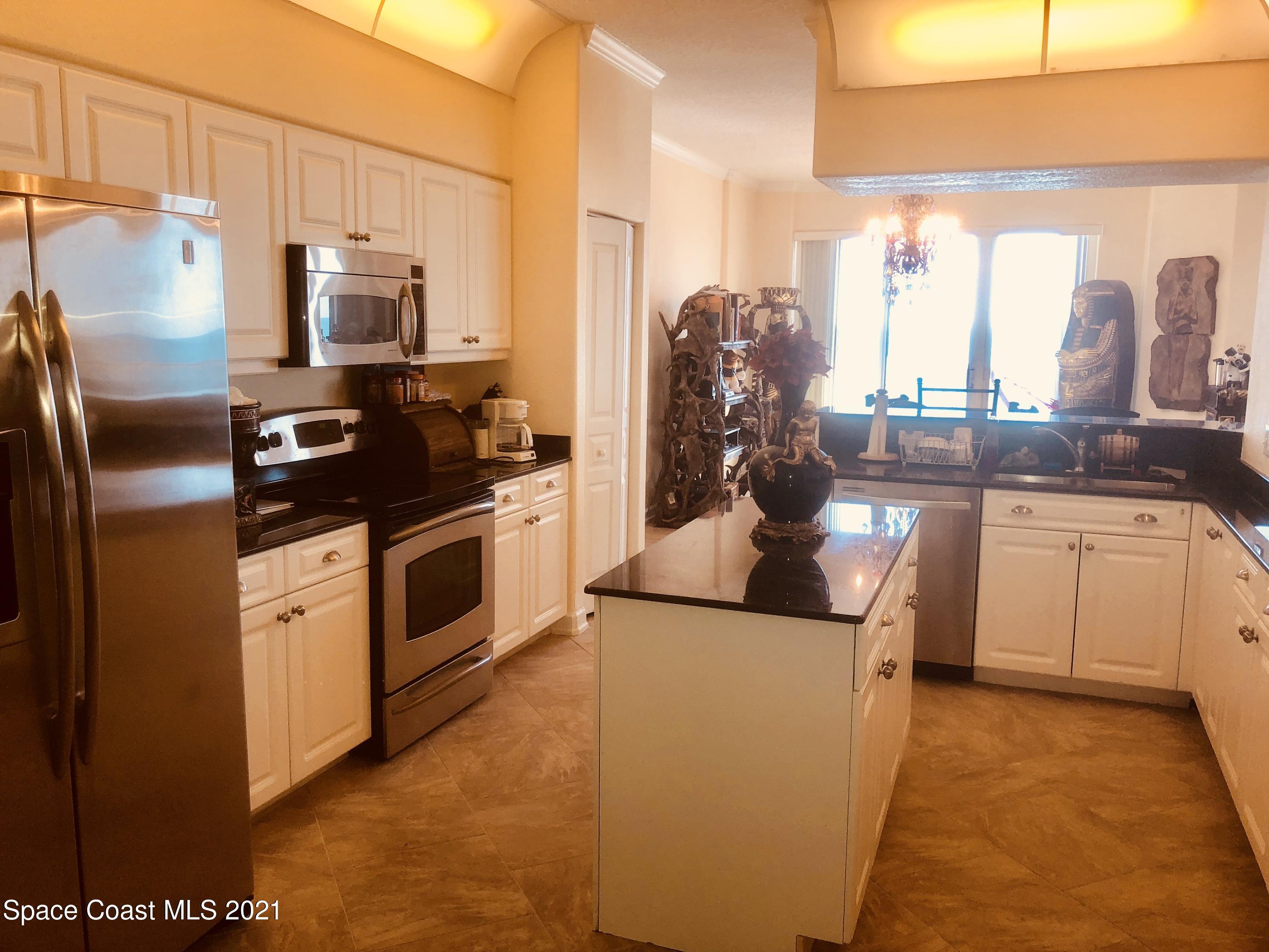 2075 Florida A1A, Unit 2705 Indian Harbour Beach, FL 32937 - Photo 6 of 30 a kitchen with stainless steel appliances a refrigerator sink and cabinets