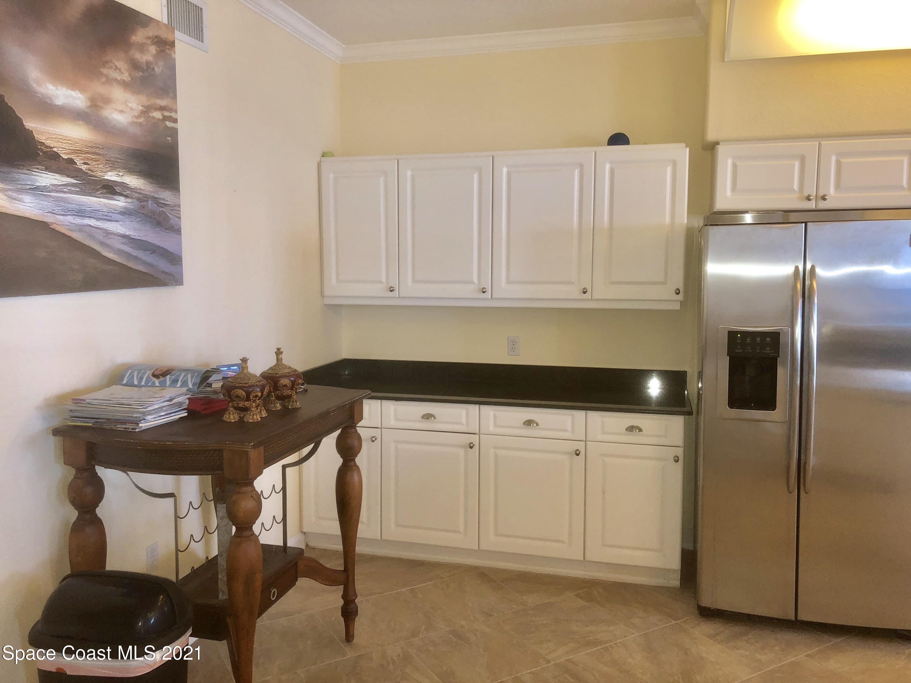 2075 Florida A1A, Unit 2705 Indian Harbour Beach, FL 32937 - Photo 7 of 30 a kitchen with a sink cabinets and appliances