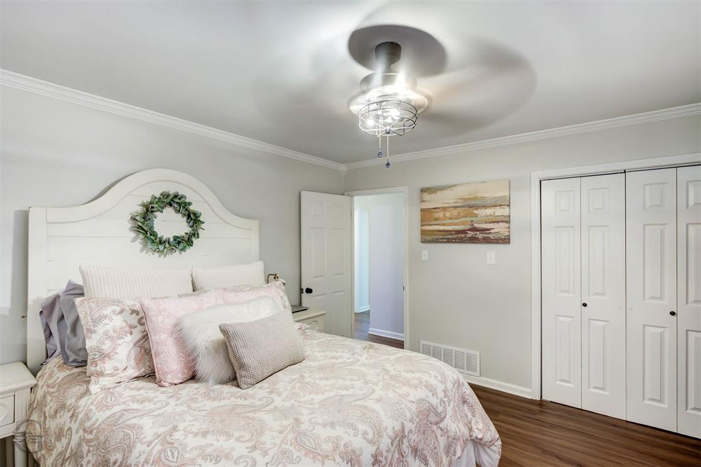 701 Chandler Road Haughton, LA 71037 - Photo 19 of 25 a bedroom with a large bed and a chandelier