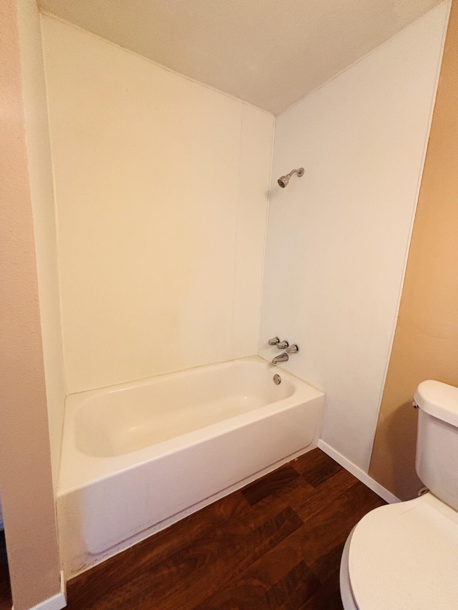 1108 41st Street Lubbock, TX 79412 - Photo 18 of 21 a bathroom with a bathtub and toilet