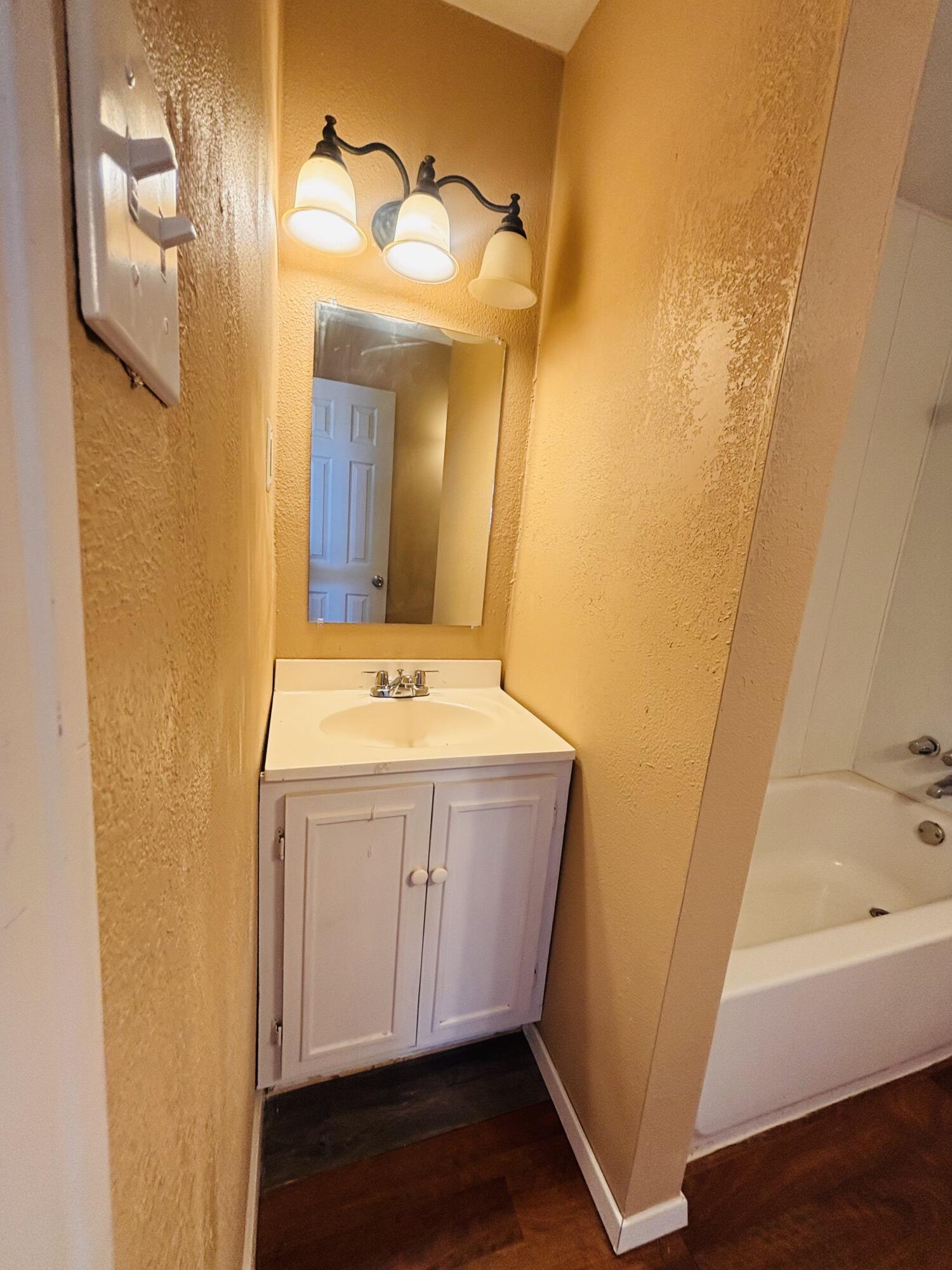 1108 41st Street Lubbock, TX 79412 - Photo 19 of 21 a bathroom with a sink and a mirror