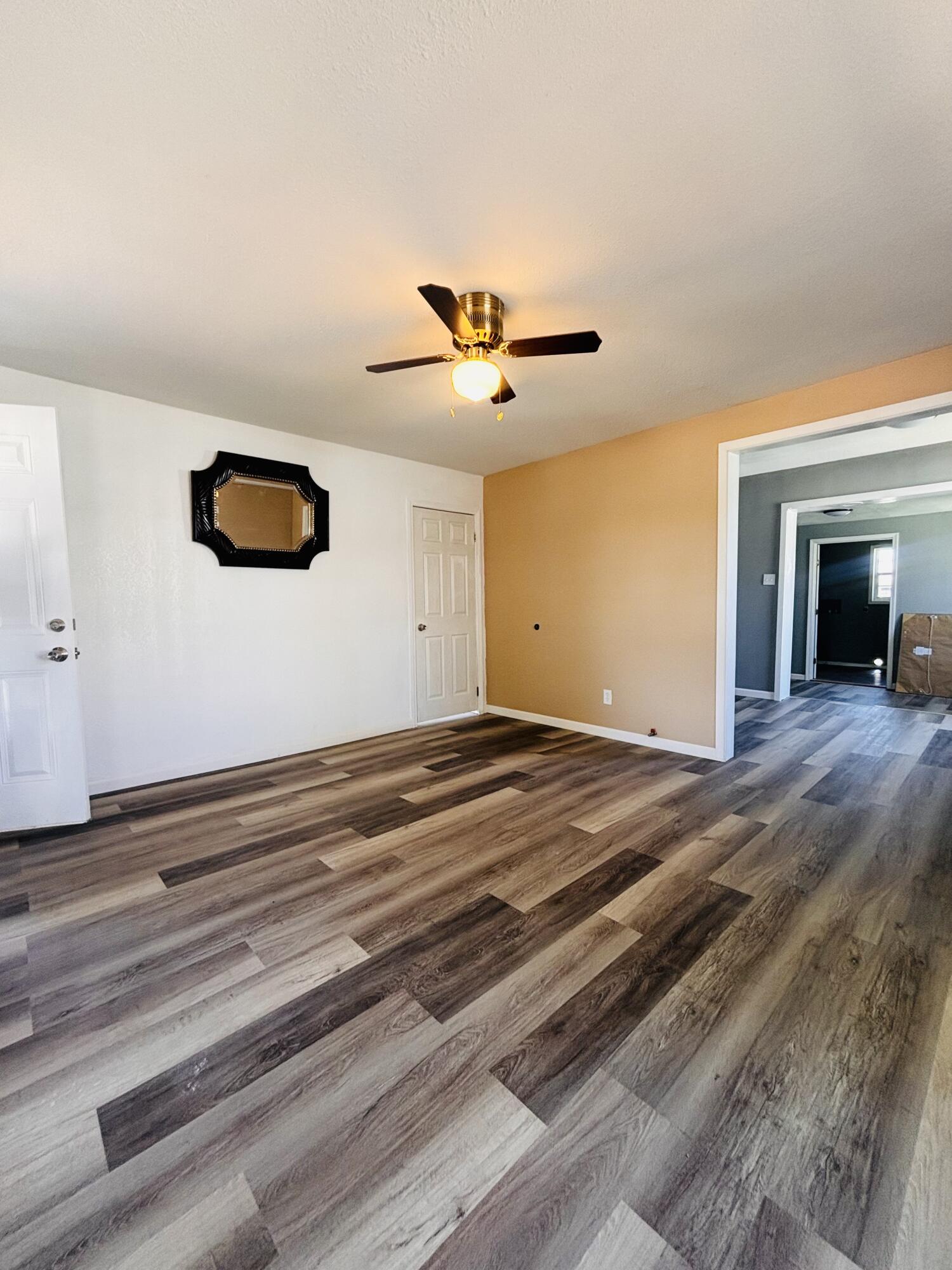 1108 41st Street Lubbock, TX 79412 - Photo 6 of 21 a view of a livingroom with a ceiling fan and hardwood floor
