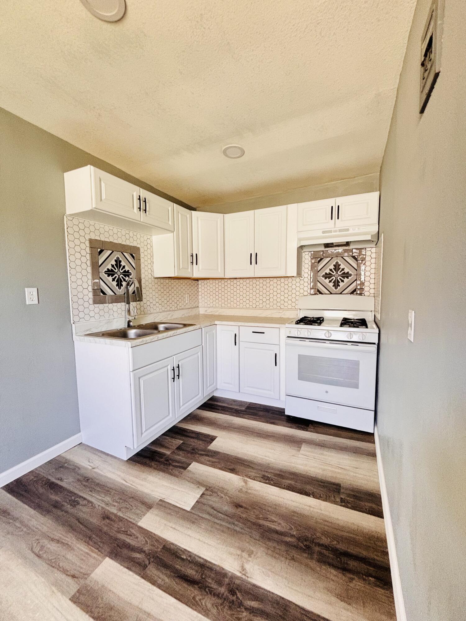 1108 41st Street Lubbock, TX 79412 - Photo 8 of 21 a kitchen with stainless steel appliances cabinets and a window