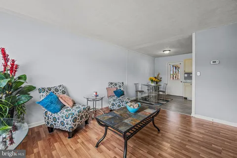 a living room with furniture and flowers